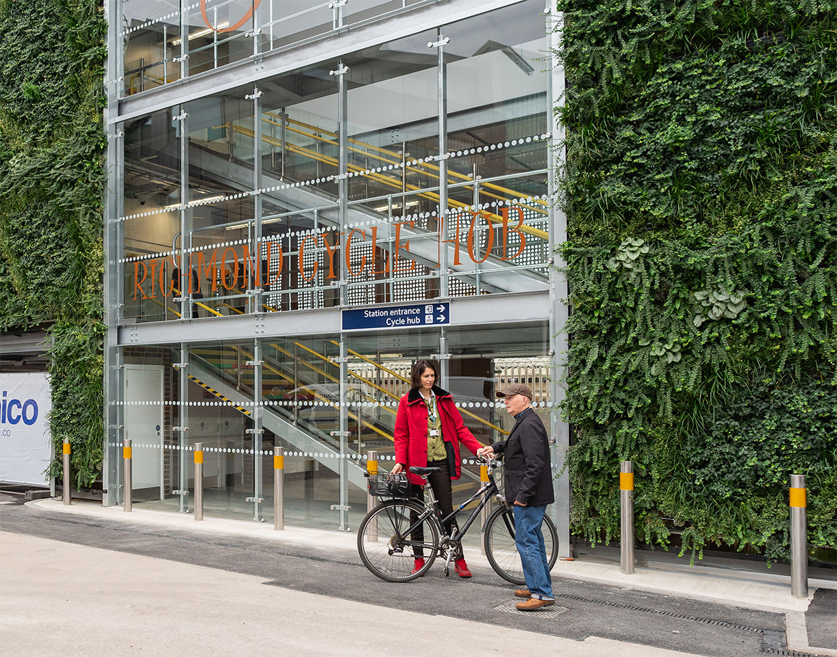Richmond cycle hub with cyclist and pedestrian in front of it